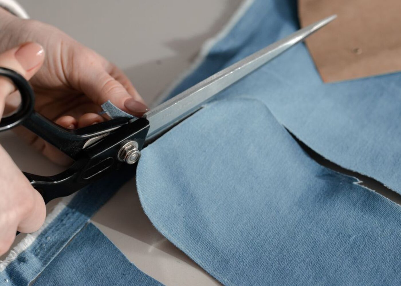 Cutting the panels of a garment by hand on our cutting floor